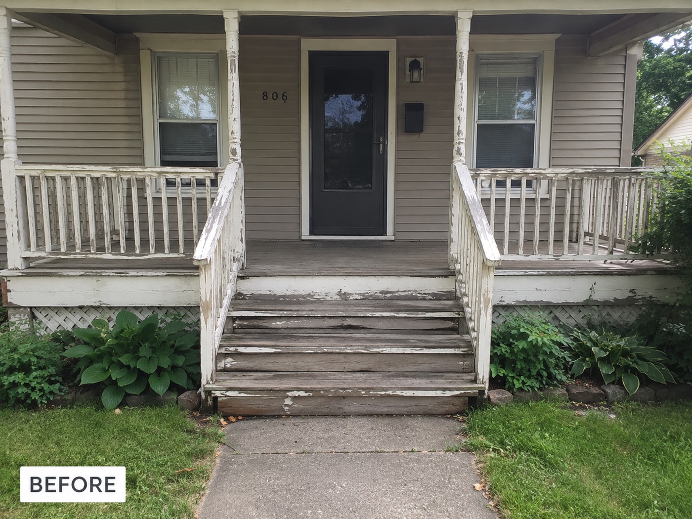 A front porch before renovation — peeling paint and weathered wooden steps
